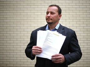 Jerrod Lacelle, who has spent the last five months trying to resolve a dispute with Air Canada, holds some of his correspondence with the airline.