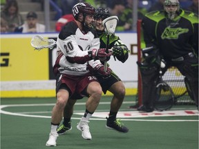 Colorado Mammoth's Jacob Ruest holds on to the ball while Saskatchewan Rush defender Nik Bilic guards from behind at the SaskTel Centre on Saturday, March 11, 2017.