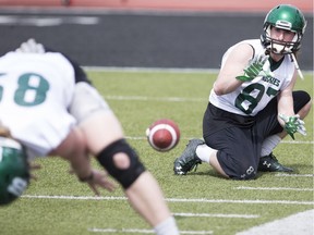 Emmett Tims snaps the ball to Mitch Hillis during practice at Griffiths Stadium for the Huskies Spring Camp on May 6, 2017.
