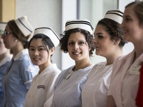 Shalla Sharma (center)  shows off a old nurse uniform during a fashion show for the 50th anniversary for the programme at Sask Polytechnic in Saskatoon, SK on Saturday, May 13, 2017. (Saskatoon StarPhoenix/Kayle Neis)