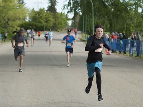 Shaidon Yuzik from Martensville runs to the finish line after competing in the 5k race at the Saskatchewan Marathon in Saskatoon, SK on May 28, 2017.