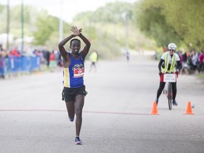 Teresa Fekensa celebrates after finishing first in the Saskatchewan Marathon held at Diefenbaker Park in Saskatoon on May 28, 2017.