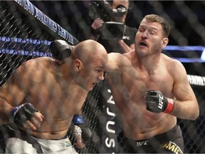 Stipe Miocic, lands a right against Junior Dos Santos in a mixed martial arts bout at UFC 211 for the UFC heavyweight championship, Saturday, May 13, 2017, in Dallas. Miocic retained his heavyweight title.