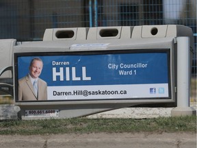 City Councillor Darren Hill is pictured on a bus stop sign rental at 33rd Street and Avenue P in Saskatoon on May 3, 2016.