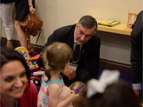 Saskatchewan Education Minister Don Morgan plays with a young child in Ottawa during an annoucement that will see $39 million in federal funding flow to Saskatchewan for Early Learning and Child Care improvements on June 12, 2017. Some in the education sector say the funding is welcome news as there is a growing need for Early Learning and Child Care supports in the province.