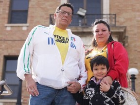 Vince Bear and Raelene Adam, together with their younger son, Hayden, on the steps of Prince Albert's Court of Queen's Bench.