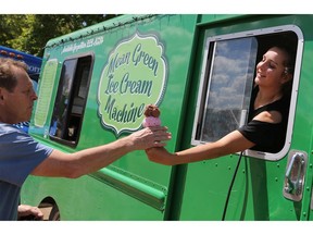 Ashley Kenbeigz serves up an ice cream cone during the Food Truck Wars event at the Sutherland Curling Club in Saskatoon on June 18, 2017.