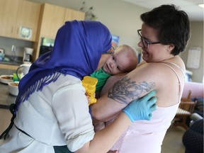 Peer support worker for the Mothers' Centre breastfeeding program Jasmyn Marshall and her 15-month-old son Victor Marshall get his and kisses at Station 20 West in Saskatoon on June 19, 2017.