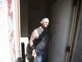 Sheldon Tarry, a tenant of a problem rental house shows off the back door where he claims squatters downstairs have destroyed the property in Saskatoon, Sask. on Friday, June 23, 2017.