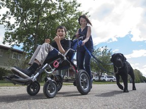 DALMENY,SK--JUNE 23 2017-0623-NEWS-AUTISM- Gabriel Gagnon and his mother Pearl Gagnon go for a walk in Dalmeny with their service dog Andy, Pearl who has received Andy from the nonprofit organization Pawsitive Independence uses the service dog to help support her son who is diagnosed with Autism in Dalmeny, SK on Friday, June 23, 2017. (Saskatoon StarPhoenix/Kayle Neis)
Kayle Neis, Saskatoon StarPhoenix