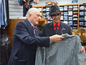 Frank Atchison (left) shows a shirt to customer Ed Ross (right) at his clothing store on June 22, 2017. Atchison is planning to retire and close down the store after 46 years in business.
(Matthew Olson / Saskatoon StarPhoenix)
