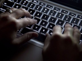 A woman types on her computer keyboard.