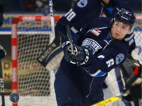 Saskatoon Blades' D-man Mark Rubinchik shoots the puck away from his net against the Moose Jaw Warriors at SaskTel Centre