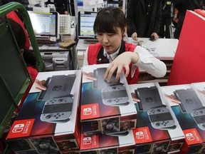 Employee of the electronics retailer Bic Camera sells Nintendo&#039;s newest computer game &quot;Switch&quot; at a retail store in central Tokyo, Friday, March 3, 2017. Nintendo is counting on Mario, Link and its other heroes to protect the Switch from suffering the same fate as its predecessor. THE CANADIAN PRESS/AP-Koji Sasahara