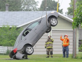 Fire crews were called out to deal with a car found hanging from the guide line to a power pole in Nipawin, SK on June 22, 2017. (Nipawin Journal)