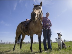 Jody Busch and her dog Bree exercise horses at River’s Edge Stables in Saskatoon.