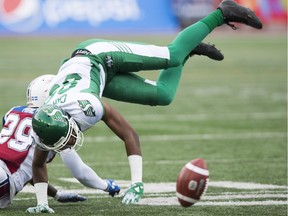 The Saskatchewan Roughriders' Duron Carter loses control of the football in the vicinity of Montreal Alouettes defensive back Jonathon Mincy on Thursday at Percival Molson Memorial Stadium.
