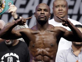 Floyd Mayweather Jr.

FILE - In this Sept. 12, 2014, file photo, Floyd Mayweather Jr. poses on the scale during a weigh in for a fight against Marcos Maidana in Las Vegas. Mayweather Jr. said Wednesday, June 14, 2017,  he will come out of retirement to face UFC star Conor McGregor in a boxing match on Aug. 26. Mayweather, who retired in September 2015 after winning all 49 of his pro fights, will face a mixed martial arts fighter who has never been in a scheduled 12-round fight at the MGM Grand arena. The fight will take place in a boxing ring and be governed by boxing rules.  (AP Photo/John Locher, File) ORG XMIT: NY170

A SEPT. 12, 2014 FILE PHOTO
John Locher, AP