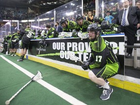 Saskatchewan Rush forward Robert Church looks onto the field as the Georgia Swarm celebrates after defeating the Rush 15-14 to win its first-ever NLL Champion's Cup.