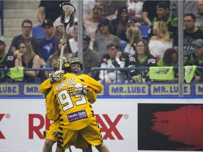 Saskatchewan Rush forward Robert Church goes to move the ball around Georgia Swarm defender John Ranagan during Game 2 of the Champion's Cup.