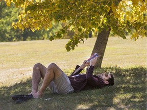 Alexis Combe enjoys some reading in the shade of Victoria Park, Thursday, September 15, 2016.