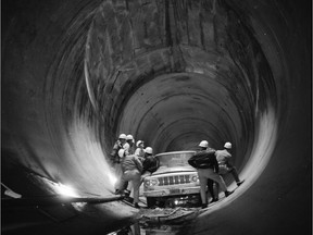 Workers stand in one of five 20-foot-diameter tunnels under what is now Lake Diefenbaker during construction on the Gardiner Dam, which will turn 50 years old in July 2017. The tunnels now transport water from the dam to the nearby Coteau Creek Power Station.