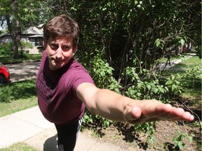 Standing six-foot-three, Jim Ginther, who plans on participating in Big Guy Yoga, strains as he tries to pull off a yoga pose on his front lawn on June 1, 2017. Taking a break from yoga for roughly three years, he said he's excited about Thursday's class, as it will allow him to get a re-introduction amongst other 'big guys' in a comfortable and welcoming environment. (Morgan Modjeski/The Saskatoon StarPhoenix)