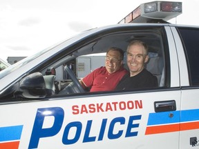 Former Saskatoon mayor Don Atchison, left, gives retiring police Chief Clive Weighill credit for helping restore residents' confidence in the police force. Here, the two pose together in a police car at the Saskatoon International Raceway in June of 2007. (GORD WALDNER/The StarPhoenix)