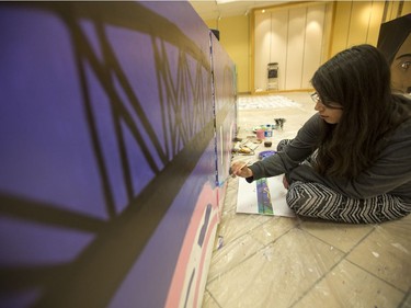 Tonia Bird works on a piece for the children's festival during the Urban Canvas program in May.