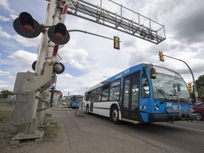 A Saskatoon Transit bus crosses the railway tracks near the intersection of 22nd Street West and Avenue F North in Saskatoon on Friday, June 16, 2017. Saskatoon city council will be asked to approve a $3-million contract Wednesday to plan and design a bus rapid transit system that includes a corridor on 22nd.(Liam Richards/The StarPhoenix)