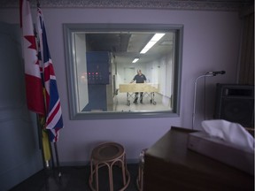 Blair Derkachenko with Prairie View Crematorium demonstrates how they load the furnaces for cremating bodies in Saskatoon, Sask. with an empty casket on Thursday, June 22, 2017. (Saskatoon StarPhoenix/David Stobbe)