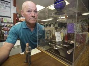 Chris Kinzel, owner of Funk’s Furniture Repairs and Antiques, poses with his silverware collection owned by John A. Macdonald. (Saskatoon StarPhoenix/Liam Richards)