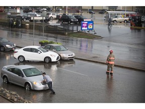 SASKATOON,SK--JULY 10/2019-0711 News Weather- Saskatoon Fire and Police respond to flooding at the intersection of Confederation Drive and Laurier Drive in Saskatoon, SK on Monday, July 10, 2017. (Saskatoon StarPhoenix/Liam Richards)
Liam Richards, Saskatoon StarPhoenix