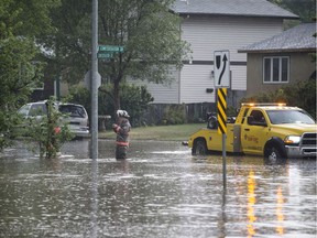 Saskatoon Fire and Police respond to flooding at the intersection of Confederation Drive and Laurier Drive in Saskatoon, SK on Monday, July 10, 2017. (Saskatoon StarPhoenix/Liam Richards)
Liam Richards, Saskatoon StarPhoenix