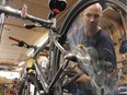 Jay Woytowich, owner of Doug's Spoke N' Sport, works on a bike at the store's workshop on July 10, 2017, he says only time will tell if the Saskatoon Police Service's new bike registry will help reduce the number of bike thefts in the city.
