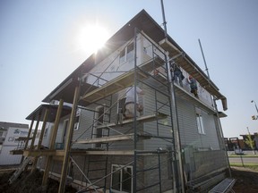 Volunteers work on a Habitat for Humanity home under construction on Slimmon Road on July 13, 2017.