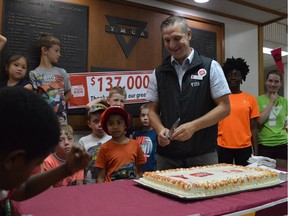 The YMCA of Saskatoon and CEO Dean Dodge (right) celebrates beating their goal by raising more than $130,000 for their Strong Kids Campaign this year on July 14, 2017. (Matthew Olson / Saskatoon StarPhoenix)