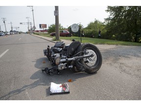 Saskatoon police, firefighters and ambulance staff responded to a collision between a car and a motorcycle at Central Avenue and Grey Avenue on Wednesday. The rider, a 25-year-old man, was seriously injured. (Saskatoon StarPhoenix/Liam Richards)