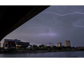 Lighting shoots across the South Saskatchewan River over the Remai Modern art gallery and River Landing on July 20, 2017.