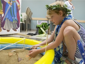 Stella DeClerq digs through a mock archaeological dig at Time Travellers Camp at the University of Saskatchewan.