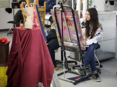 Tonia Bird works on a charcoal self-portrait during the first week of the Urban Canvas program in October.