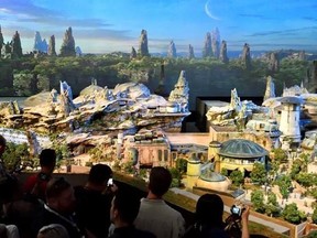 Members of the media get their first look at a 50-foot, detailed model of &ampquot;Star Wars&ampquot; land during a media preview for Disney&#039;s D23 Expo in Anaheim, Calf., on Thursday, July 13, 2017. (Jeff Gritchen/The Orange County Register via AP)