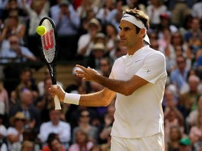Switzerland&#039;s Roger Federer pats the ball back to a ballboy after holding serve as he plays his Men&#039;s Singles semifinal match against Czech Republic&#039;s Tomas Berdych on day eleven at the Wimbledon Tennis Championships in London, Friday, July 14, 2017. (AP Photo/Alastair Grant)