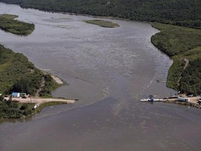 Crews work to clean up an oil spill on the North Saskatchewan river near Maidstone, Sask. on Friday, July 22, 2016. A year after a major oil spill along the North Saskatchewan River fouled the water source for three Saskatchewan cities, an environmentalist says the company involved should get more than just &ampquot;a slap on the wrist.&ampquot; THE CANADIAN PRESS/Jason Franson