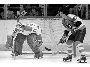 Reggie Leach, right, pictured during his playing days with the Philadelphia Flyers in 1976.