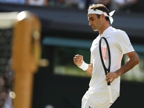 Switzerland's Roger Federer celebrates winning a point against Canada's Milos Raonic during their men's singles quarter-final match on the ninth day of the 2017 Wimbledon Championships at The All England Lawn Tennis Club in Wimbledon, southwest London, on July 12, 2017
