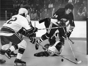 New York Islanders Bob Bourne leaps over rookie Vancouver Canucks goalie Murray Mannerman while defenceman John Grisdale and Bob Manno help clear the puck during NHL action at the Pacific Coliseum, September 28, 1977.    (Ralph Bower/Vancouver Sun) [PNG Merlin Archive]
Ralph Bower, Vancouver Sun