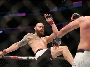 FILE -  In this Jan. 17, 2016, file photo, Travis Browne, left, fights against Matt Mitrione in their mixed martial arts bout at UFC Fight Night 81, in Boston.