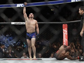 Robert Whittaker celebrates after defeating Yoel Romero in a middleweight championship mixed martial arts bout at UFC 213, Saturday, July 8, 2017, in Las Vegas. (AP Photo/John Locher)p ORG XMIT: NVJL123
John Locher, AP