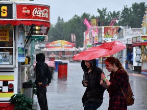 Thunderstorms and lightning soaked the ground at the Saskatoon Exhibition, but it couldn't keep people completely away from the fairgrounds.